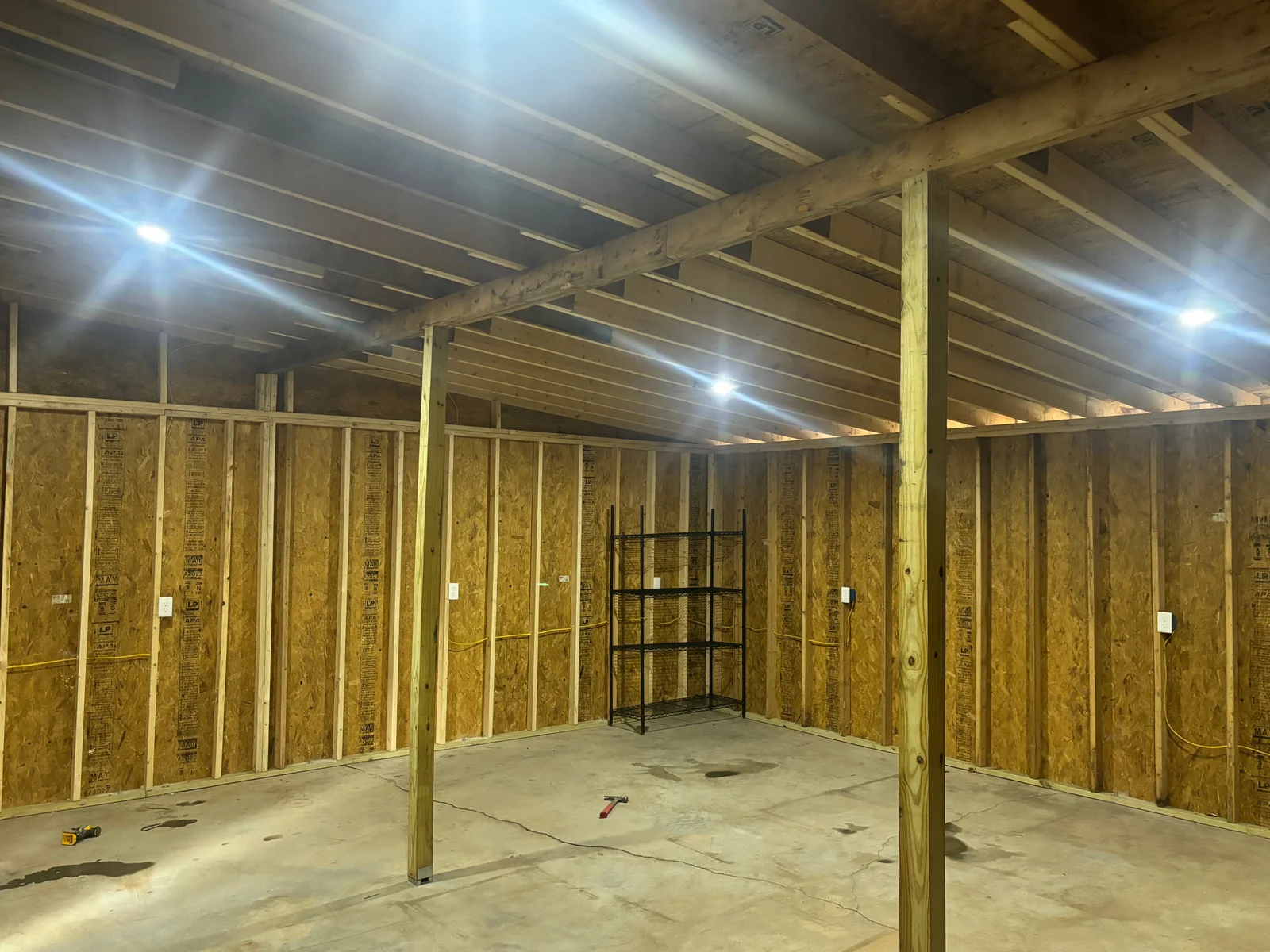 Construction-stage wiring and recessed lighting in a wood-framed building