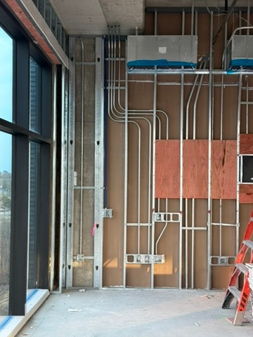 Conduit and device boxes in a framed wall