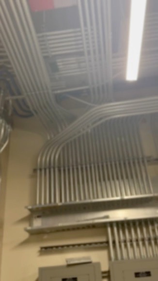 Conduit runs above electrical panels